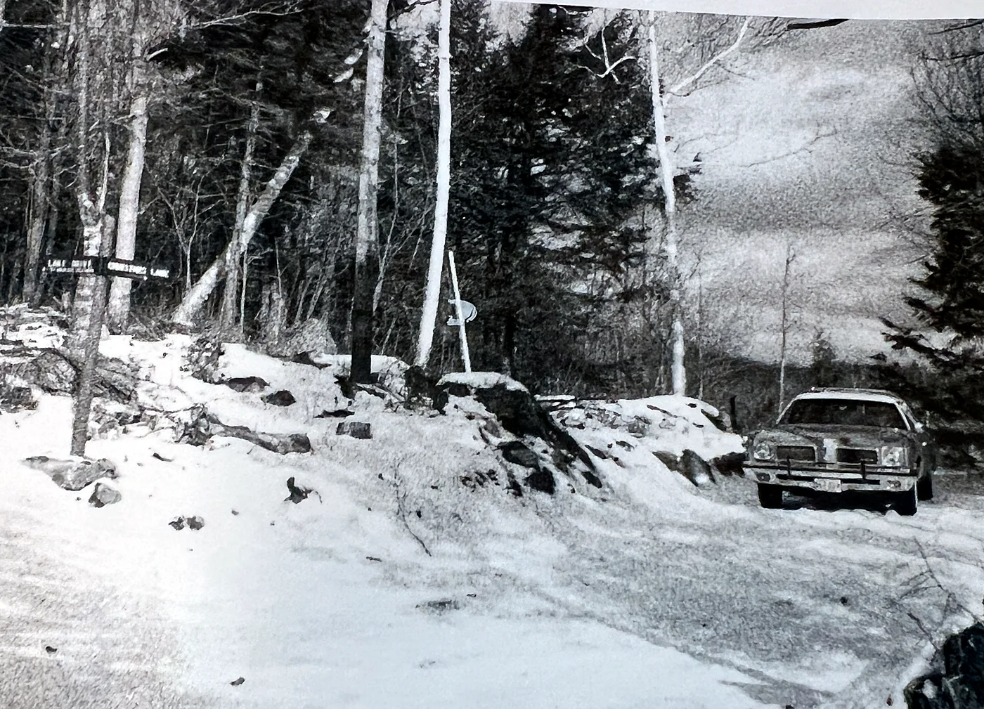 The car Robert Logan Bull drove, at the top of the Lodge hill near the well — with the old Christmas Lane and Lake Drive sign. When the prop…
